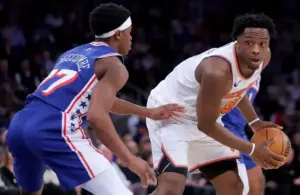 New York Knicks forward OG Anunoby (8) controls the ball against Philadelphia 76ers guard VJ Edgecombe (77) during the second quarter of game one of the eastern conference semifinal round of the 2026 NBA Playoffs.