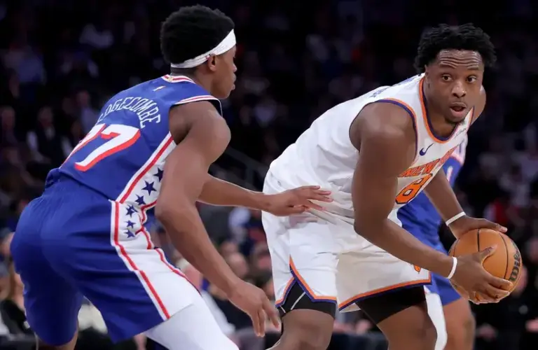 New York Knicks forward OG Anunoby (8) controls the ball against Philadelphia 76ers guard VJ Edgecombe (77) during the second quarter of game one of the eastern conference semifinal round of the 2026 NBA Playoffs.