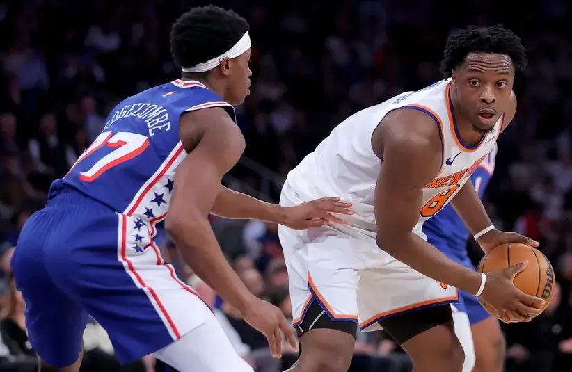 New York Knicks forward OG Anunoby (8) controls the ball against Philadelphia 76ers guard VJ Edgecombe (77) during the second quarter of game one of the eastern conference semifinal round of the 2026 NBA Playoffs.