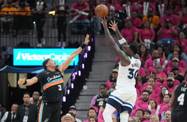 Minnesota Timberwolves forward Julius Randle (30) shoots over San Antonio Spurs forward Keldon Johnson (3).