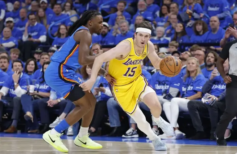 Los Angeles Lakers guard Austin Reaves (15) drives around Oklahoma City Thunder guard Cason Wallace (22).