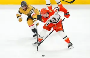 Anaheim Ducks right wing Beckett Sennecke (45) steals the puck from Vegas Golden Knights right wing Keegan Kolesar (55).
