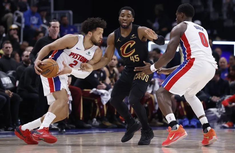 Detroit Pistons guard Cade Cunningham (2) dribbles defended by Cleveland Cavaliers guard Donovan Mitchell (45).