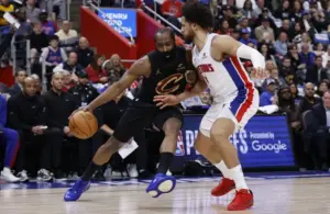 Cleveland Cavaliers guard James Harden (1) dribbles defended by Detroit Pistons guard Cade Cunningham (2)