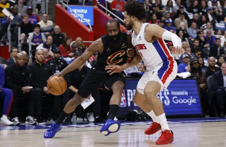 Cleveland Cavaliers guard James Harden (1) dribbles defended by Detroit Pistons guard Cade Cunningham (2)