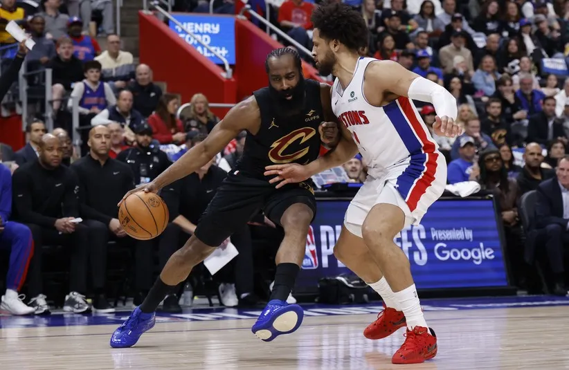 Cleveland Cavaliers guard James Harden (1) dribbles defended by Detroit Pistons guard Cade Cunningham (2)