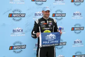 May 9, 2026; Watkins Glen, New York, USA; NASCAR Cup Series driver Shane Van Gisbergen stands with the Busch Light Pole Award after winning the pole for the Go Bowling at The Glen at Watkins Glen International.