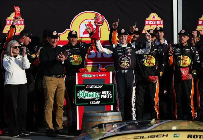 May 9, 2026; Watkins Glen, New York, USA; NASCAR O’Reilly Auto Parts Series driver Connor Zilisch raises the winner’s trophy in victory lane after winning the Mission 200 at Watkins Glen International.