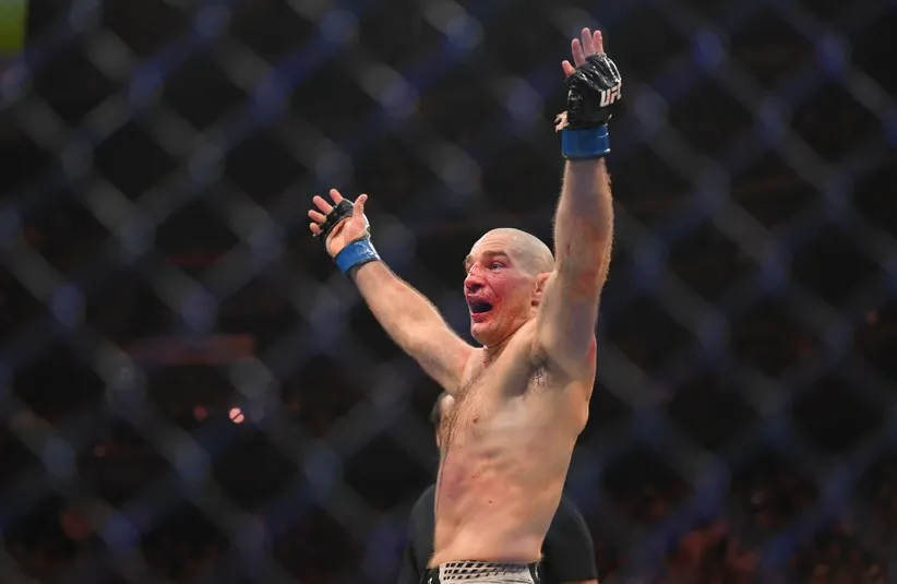 Sean Strickland (blue gloves) celebrates after defeating Khamzat Chimaev.