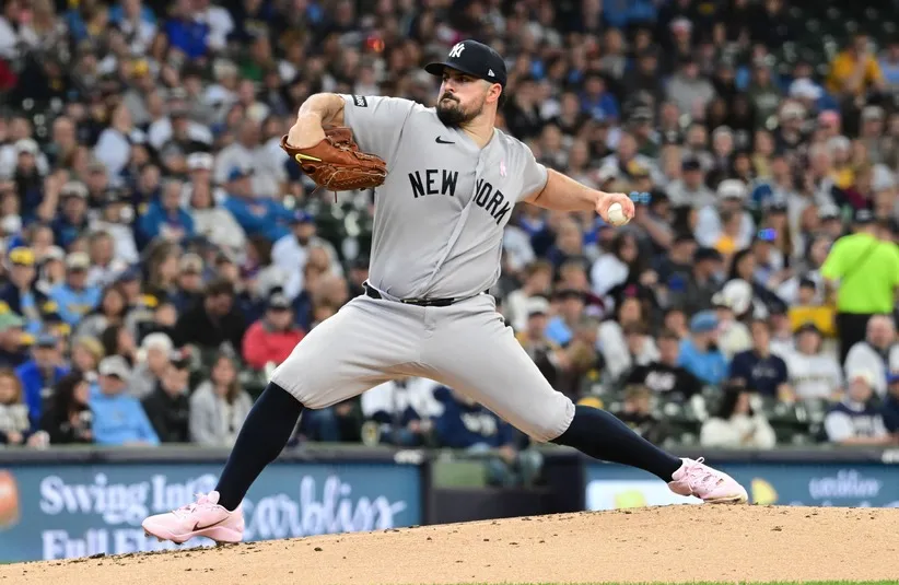 New York Yankees starting pitcher Carlos Rodon (55) throws a pitch.