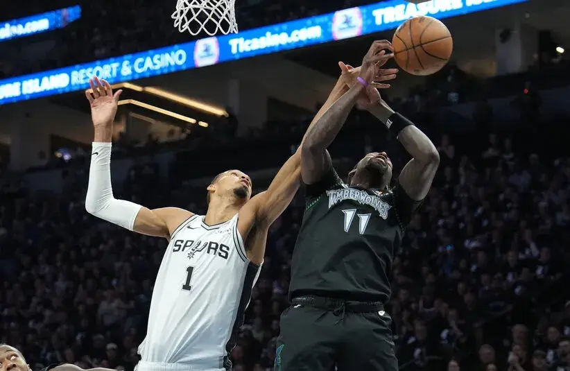 May 15, 2026; Minneapolis, Minnesota, USA; San Antonio Spurs forward Victor Wembanyama (1) and Minnesota Timberwolves center Naz Reid (11) jump for a rebound in the first half during game six of the second round of the 2026 NBA Playoffs at Target Center. Mandatory Credit: Jesse Johnson-Imagn Images
