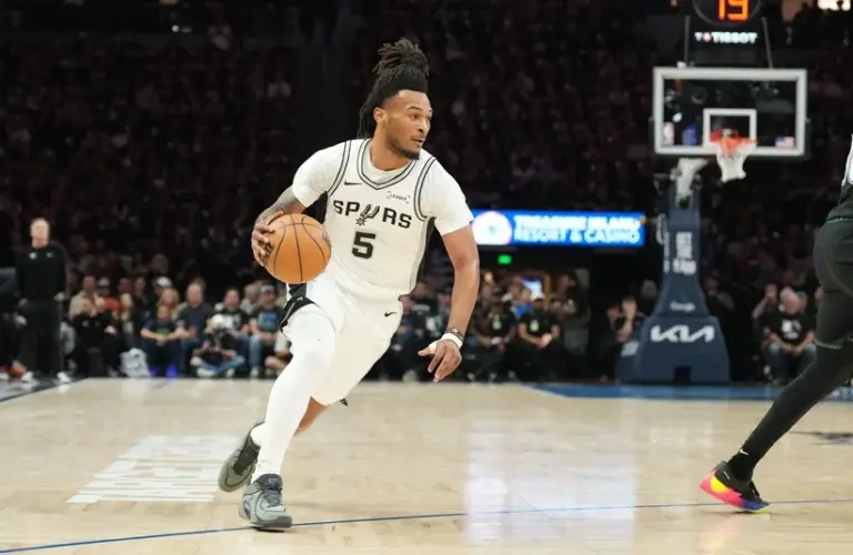 San Antonio Spurs guard Stephon Castle (5) dribbles the ball.