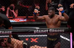 Francis Ngannou (blue gloves) reacts after fighting Philipe Lins (red gloves.