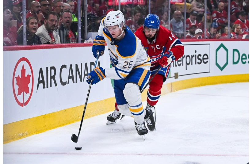 May 16, 2026; Montreal, Quebec, CAN; Buffalo Sabres defenseman Rasmus Dahlin (26) defrends the puck against Montreal Canadiens center Nick Suzuki (14) during the third period in game six of the second round of the 2026 Stanley Cup Playoffs at Bell Centre. Mandatory Credit: David Kirouac-Imagn Images