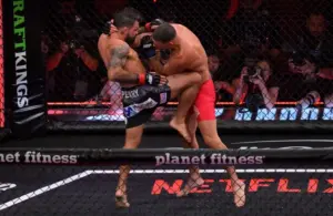 Nate Diaz (blue gloves) fights Mike Perry (red gloves) in a welterweight bout.