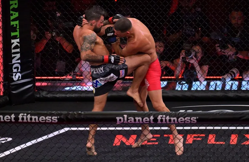 Nate Diaz (blue gloves) fights Mike Perry (red gloves) in a welterweight bout.