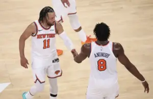 New York Knicks guard Jalen Brunson (11) celebrates with forward Og Anunoby (8).