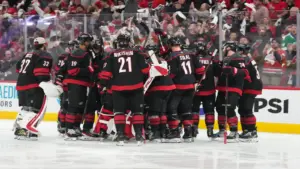 The Carolina Hurricanes celebrate after scoring an overtime goal.