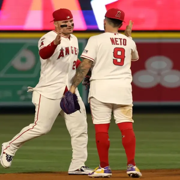 Los Angeles Angels center fielder Mike Trout (left) celebrates with shortstop Zach Neto (9).