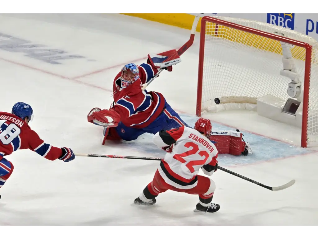 May 27, 2026; Montreal, Quebec, CAN; Carolina Hurricanes center Logan Stankoven (22) scores a goal on Montreal Canadiens goaltender Jakub Dobes (75) during the first period in game four of the Eastern Conference Final of the 2026 Stanley Cup Playoffs at Bell Centre. Mandatory Credit: Eric Bolte-Imagn Images