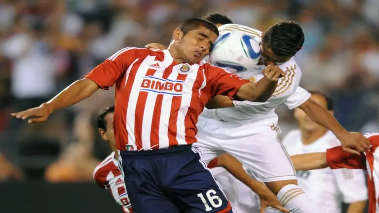 July 20, 2011; San Diego, CA, USA; CD Guadalajara defender Miguel Ronce (16) battles with Real Madrid forward Christiano Ronaldo (7) for a header on a corner kick during the first half at Qualcomm Stadium.