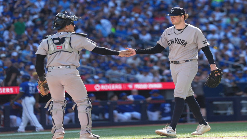 Jun 13, 2026; Toronto, Ontario, CAN; New York Yankees catcher J.C. Escarra (25) celebrates the third out with starting pitcher Cam Schlittler (31) against the Toronto Blue Jays during the seventh inning at Rogers Centre.