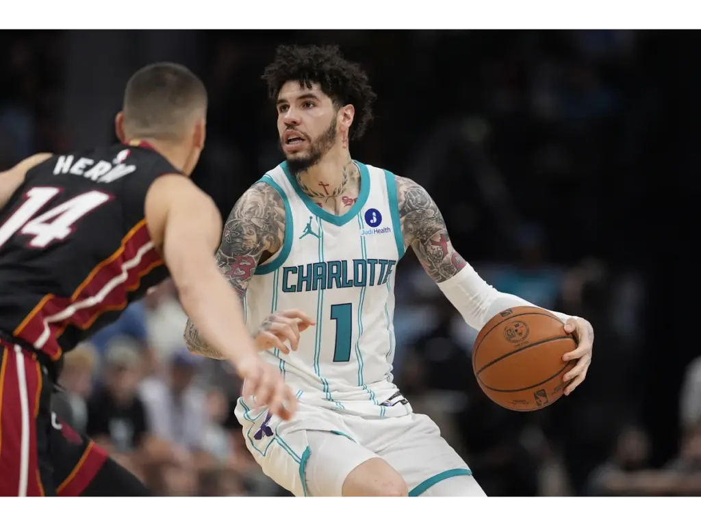 Apr 14, 2026; Charlotte, North Carolina, USA; Charlotte Hornets guard LaMelo Ball (1) looks to pass defended by Miami Heat guard Tyler Herro (14) during the second half during the play-in rounds between the Charlotte Hornets and the Miami Heat of the 2026 NBA Playoffs at Spectrum Center. Mandatory Credit: Jim Dedmon-Imagn Images