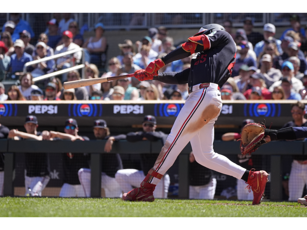 Jun 14, 2026; Minneapolis, Minnesota, USA; Minnesota Twins center fielder Byron Buxton (25) hits an RBI single against the St. Louis Cardinals in the seventh inning at Target Field. Mandatory Credit: Bruce Kluckhohn-Imagn Images