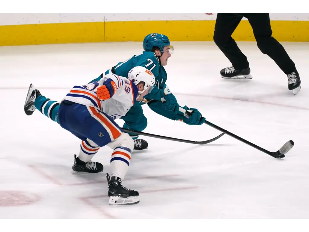 Apr 8, 2026; San Jose, California, USA; San Jose Sharks center Macklin Celebrini (71) takes a shot on goal while defended by Edmonton Oilers defenseman Ty Emberson (49) in the third period at SAP Center at San Jose. Mandatory Credit: David Gonzales-Imagn Images