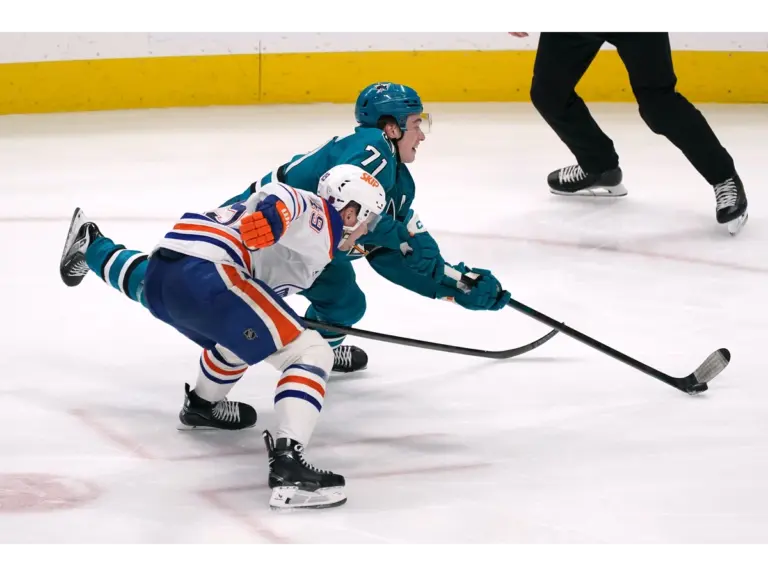 Apr 8, 2026; San Jose, California, USA; San Jose Sharks center Macklin Celebrini (71) takes a shot on goal while defended by Edmonton Oilers defenseman Ty Emberson (49) in the third period at SAP Center at San Jose. Mandatory Credit: David Gonzales-Imagn Images
