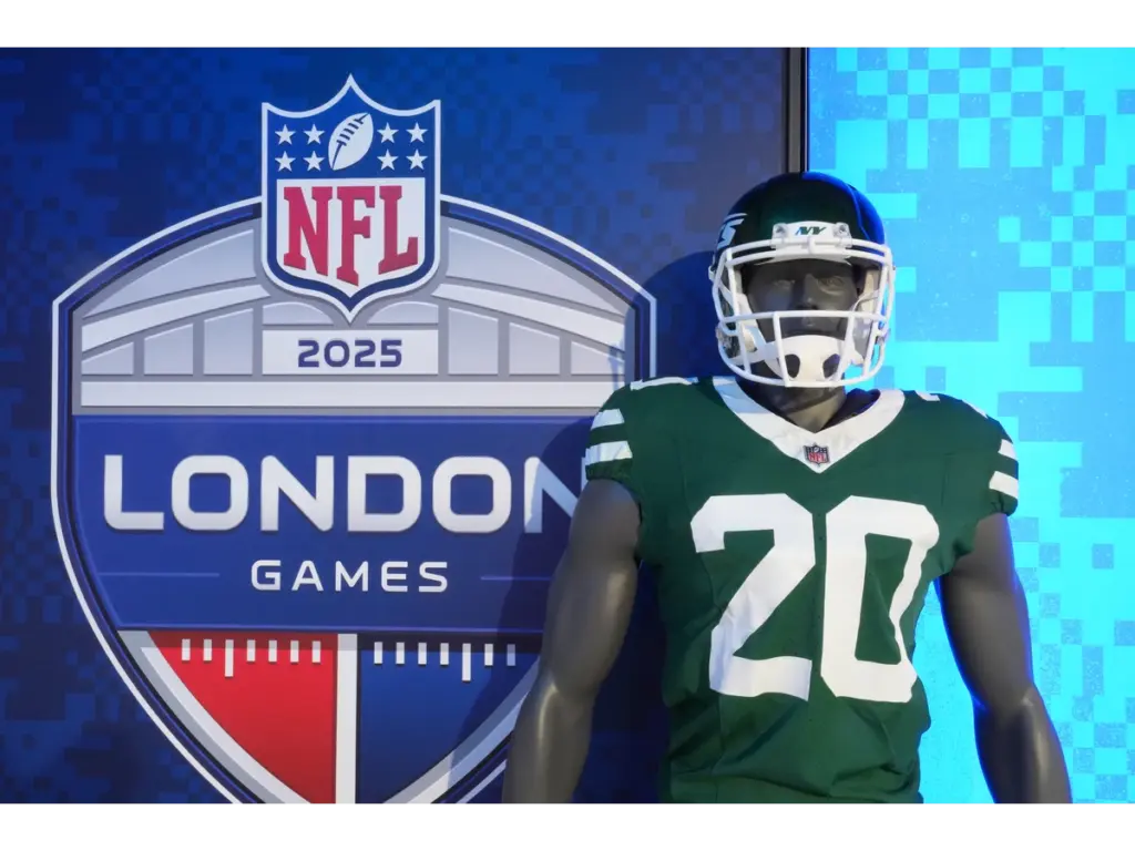 Oct 11, 2025; London, United Kingdom; The 2025 NFL London Games logo with a helmet and jersey of New York Jets running back Breece Hall (20) at the NFL Shop at Tottenham Hotspur Stadium. Mandatory Credit: Kirby Lee-Imagn Images