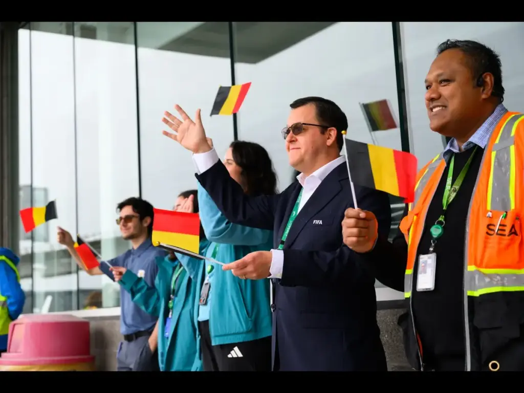 Jun 8, 2026; Seattle, Washington, USA; FIFA and airport employees wave flags as the Belgium men's national team departs the airport for the 2026 FIFA World Cup in Seattle, WA.