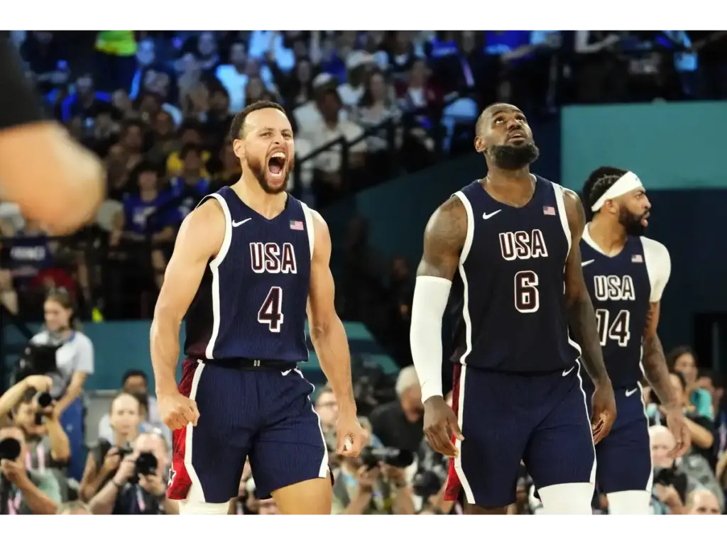 Stephen Curry (4) and guard LeBron James (6) of Team USA react in the second half against France in the men's basketball gold medal game during the Paris 2024 Olympic Summer Games at Accor Arena in Paris, France, on August 10, 2024