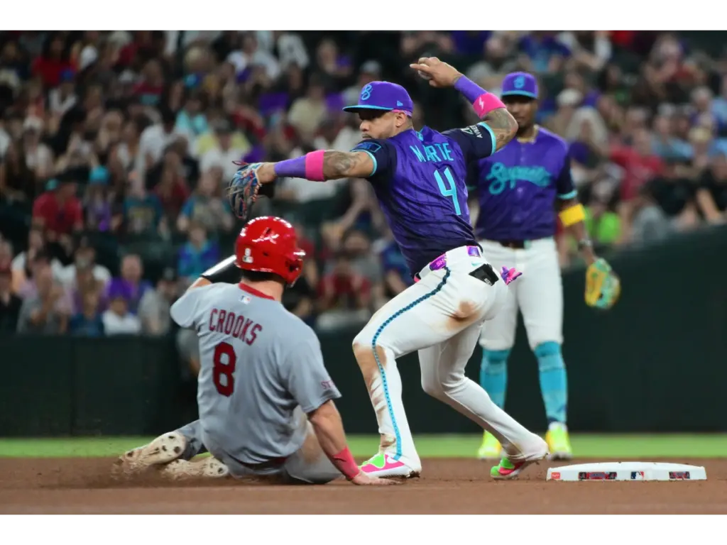 Jul 17, 2026; Phoenix, Arizona, USA; Arizona Diamondbacks second baseman Ketel Marte (4) turns a double play on St. Louis Cardinals catcher Jimmy Crooks (8) in the seventh inning at Chase Field. Mandatory Credit: Matt Kartozian-Imagn Images