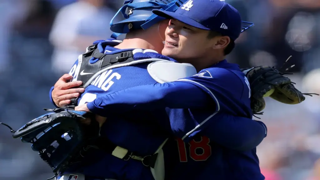 Jul 19, 2026; Bronx, New York, USA; Los Angeles Dodgers starting pitcher Yoshinobu Yamamoto (18) hugs catcher Dalton Rushing (68) after defeating the New York Yankees at Yankee Stadium.