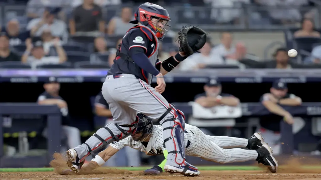 Jul 3, 2026; Bronx, New York, USA; New York Yankees shortstop Jose Caballero (72) scores a run against Minnesota Twins catcher Victor Caratini (37) on a sacrifice fly by Yankees center fielder Trent Grisham (not pictured) during the seventh inning at Yankee Stadium.
