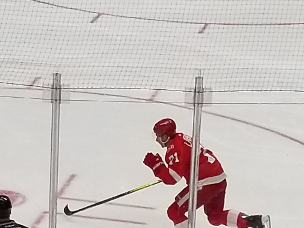Detroit Red Wings center Dylan Larkin skates during a 2018 home game; a Dylan Larkin injury will keep him out of the first two games of 2026-27, Senators vs. Red Wings