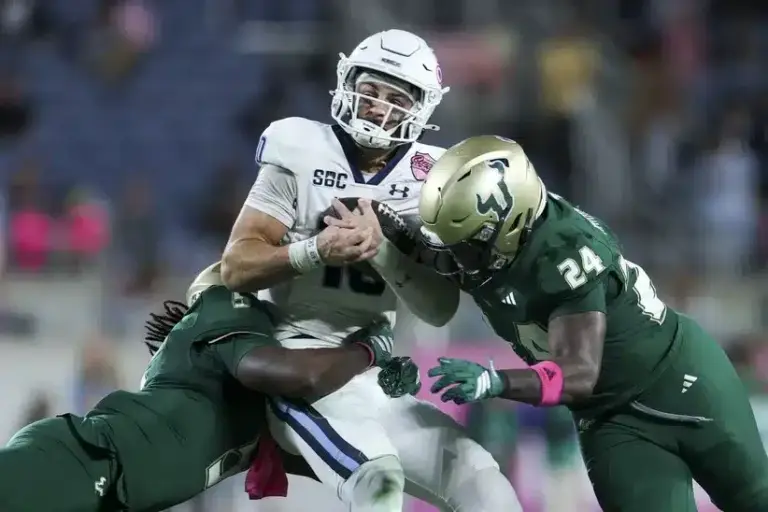 Old Dominion QB Quinn Henicle is tackled in the Cure Bowl ahead of Old Dominion vs Georgia State