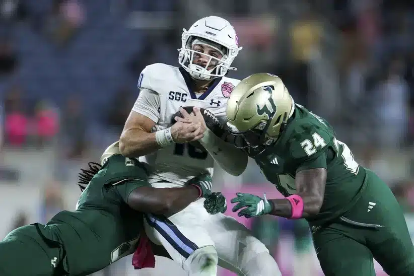 Old Dominion QB Quinn Henicle is tackled in the Cure Bowl ahead of Old Dominion vs Georgia State