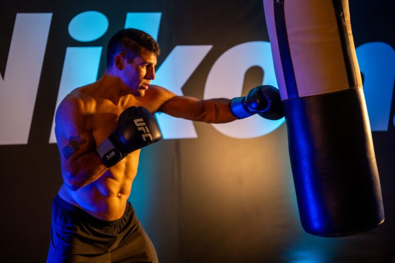 UFC 332 first-round finishes: a UFC fighter throws a punch at a heavy bag